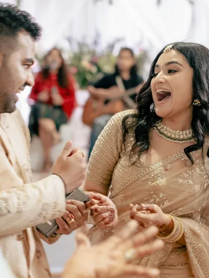A candid, interactive moment between the couple during their engagement party, full of expression and life.