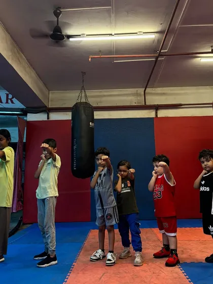 Our future champs are learning to perfect their stance and guard. This photo captures their focus and determination during a beginner boxing training session.