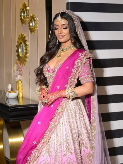 A serene moment under the veil. This shot highlights the soft, romantic quality of the makeup, which looks beautiful even through the delicate fabric.
