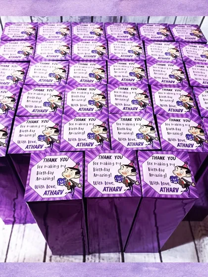 The Mr. Bean water bottles were packaged in these vibrant purple boxes with a custom thank you tag for Atharv's birthday.