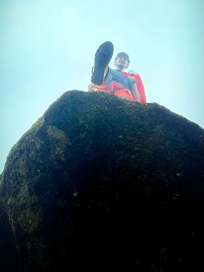 A playful moment on a moss-covered rock during the Bandaje trek. It's all about enjoying the journey.