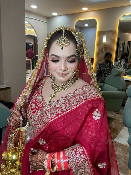 The complete bridal look for Dipika. The intricate hair accessory, the stunning jewelry, and the flawless makeup all come together to create a breathtaking vision.