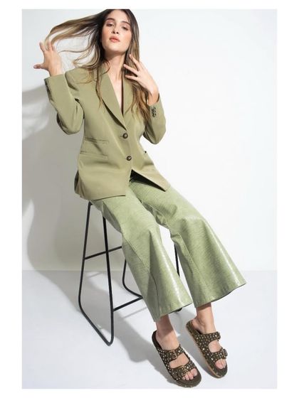 Styling for a shoe lookbook, featuring studded slide sandals. I paired them with a relaxed, monochrome green pantsuit to create a chic, gender-fluid look that feels both comfortable and fashion-forward.