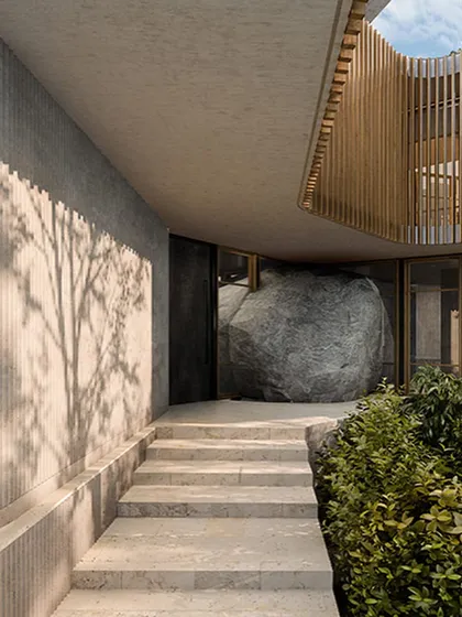 The entrance to the Lurra House in Hyderabad is defined by a massive, natural boulder. This render shows our concept of building around and with the landscape, making the earth itself a fundamental part of the architectural experience.