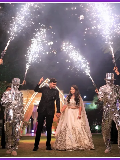 Making the couple's entry a spectacle. We arranged for mirror-costumed performers with cold pyro guns to create a dazzling and high-energy welcome for the couple.