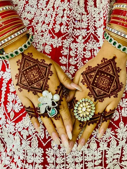A close-up of the modern geometric bridal design. The pattern is bold and symmetrical, creating a powerful statement that complements the bridal attire.