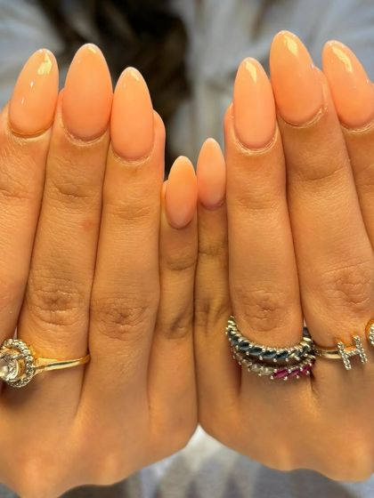 A full view of the lovely light peach extensions, showcasing the perfect shape and consistent color.