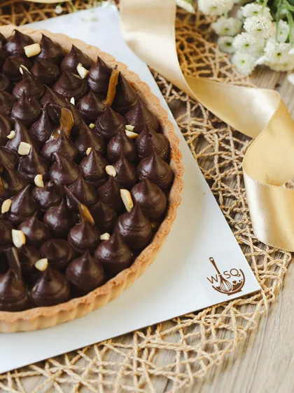 My Peanut & Chocolate Caramel Tart, with its buttery crust, gooey caramel peanut filling, and piped dark chocolate ganache topping. It's my gourmet take on a Snickers bar.