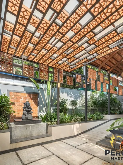 We blend traditional materials with modern architectural forms to create spaces that breathe. This project features custom-designed terracotta jali screens integrated into a pergola structure, providing natural ventilation and dappled sunlight for a serene and sustainable courtyard design.