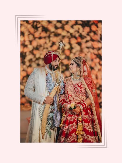 A classic portrait of the couple during the Anand Karaj ceremony, the groom holding the kirpan, symbolizing his role as a protector.