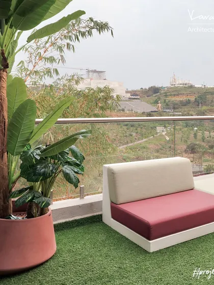 The master bedroom of Project 22 Days opens directly onto this inviting terrace. The use of artificial turf and plants ensures low maintenance while providing a lush, green escape with a stunning view.