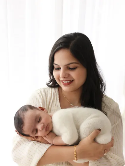 A mother's gentle hold. There's a special kind of peace in these moments. I love capturing the connection between a new mom and her baby, creating a portrait that is filled with love and tenderness.