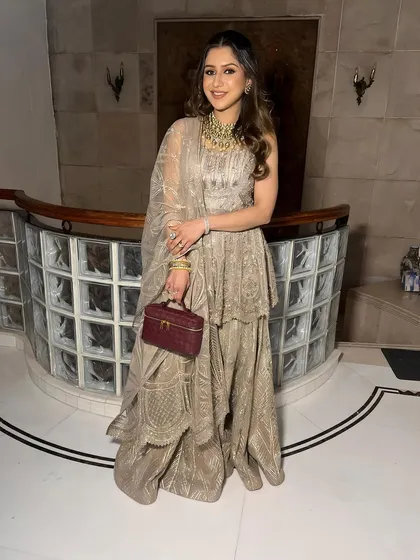 A full-length shot of the client, her elegant outfit and makeup creating a look of subtle glam.