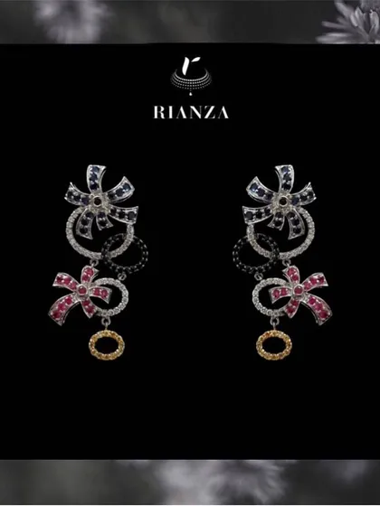 Whimsical and modern, these earrings feature a bow design crafted with blue sapphires, rubies, and diamonds. They are perfect for a bride who wants a touch of playful elegance.