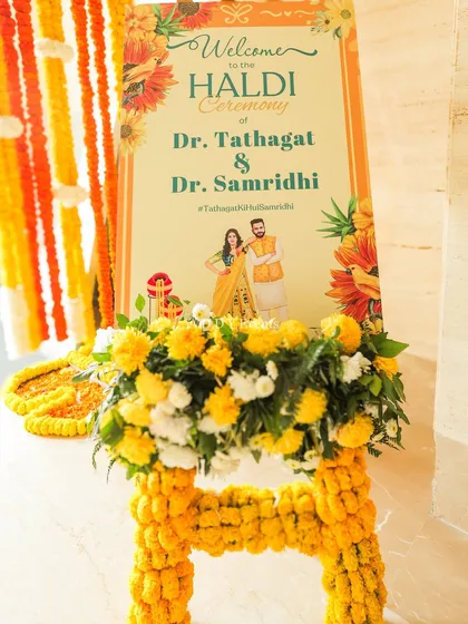 The personalized welcome sign for the Haldi ceremony of Dr. Tathagat & Dr. Samridhi, adorned with marigolds.