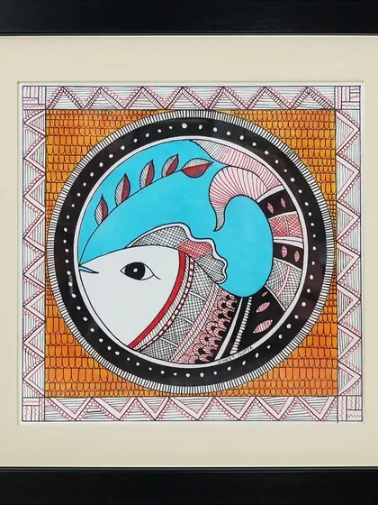 A circular composition in the Madhubani style by artist Vrishti. The painting features a stylized fish, a symbol of good luck and fertility, enclosed within a decorative, patterned border.