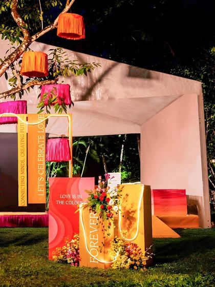 The full view of the quirky photo corner at night, with the neon lights and colorful signs creating a fun and inviting atmosphere.