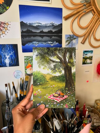 Holding the finished picnic painting in my studio, a little piece of sunshine and happiness.