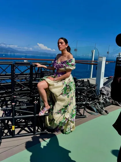 This behind-the-scenes shot captures the drama and beauty of the Yara Shoemaker gown against the open sea.
