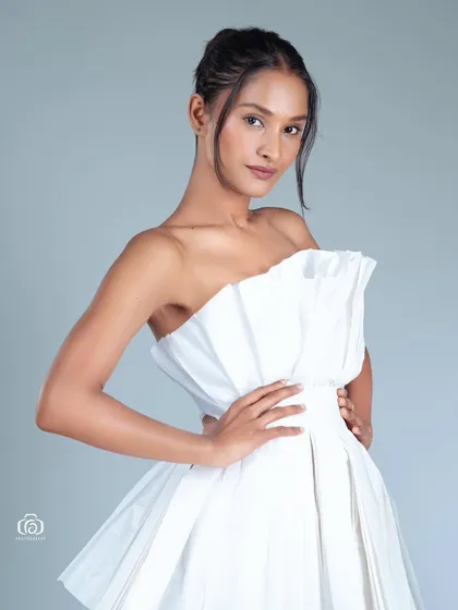 A close-up of the paper dress concept, showing the detail of the folded material. This type of creative studio work is perfect for designers or models looking for unique portfolio pieces.