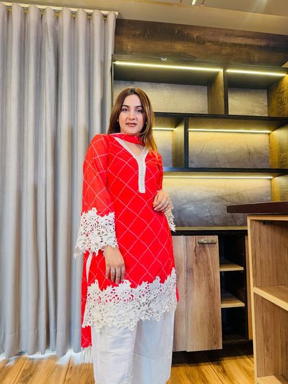 This perfectly balanced red and white suit is a must-buy. The bold red kurta is tempered with delicate cotton lace detailing, creating a look that is both festive and graceful.