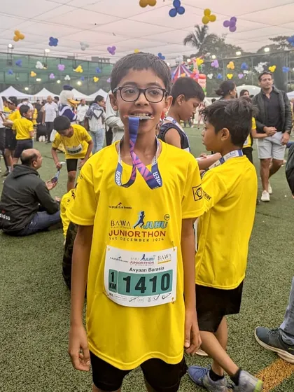 A proud finisher at the juniorthon. Every race completed is a huge victory and a step forward in their athletic journey.