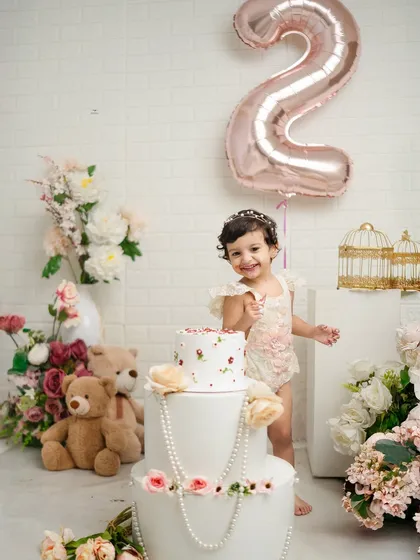 A cheeky smile from the birthday girl as she gets ready to dig into her cake. These candid moments are what make birthday photoshoots so special.