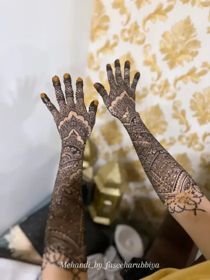 A full view of Shaziya's engagement henna, showing the stain beginning to develop on the fingertips.