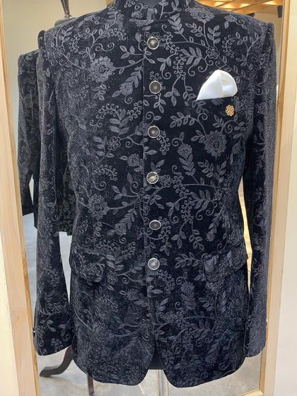 A black velvet bandhgala with all-over tonal floral thread embroidery. This piece is rich in texture and detail, perfect for an elegant evening affair.