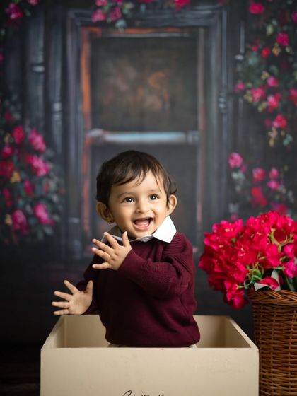 Waving at the camera! This shot captures the playful and interactive nature of a toddler milestone session.