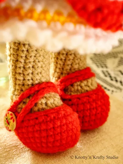 A close up of Lily's tiny red shoes, complete with little button clasps. Her shoes, like her dress, are completely removable, making dress-up play even more fun.