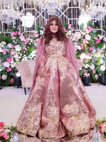 A full-length shot of my reception look. I felt like a real-life Barbie getting ready to marry my Ken. The sequined gown and feathered cape were a dream come true.