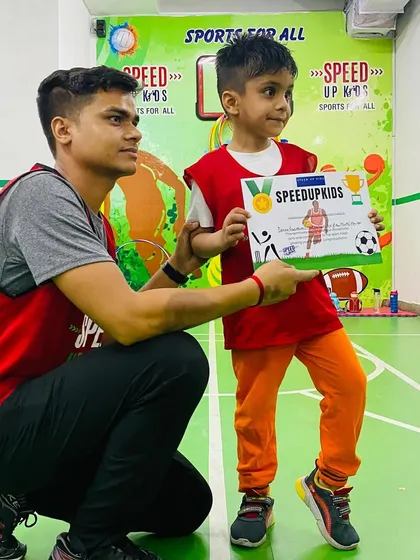 A close-up of Daksh proudly holding his certificate. This recognition is for his hard work and dedication.