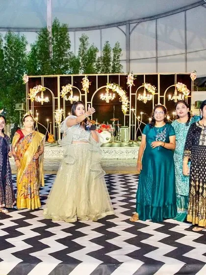 A group of guests enjoying the party and taking a selfie on the dance floor. We love creating spaces that bring people together.