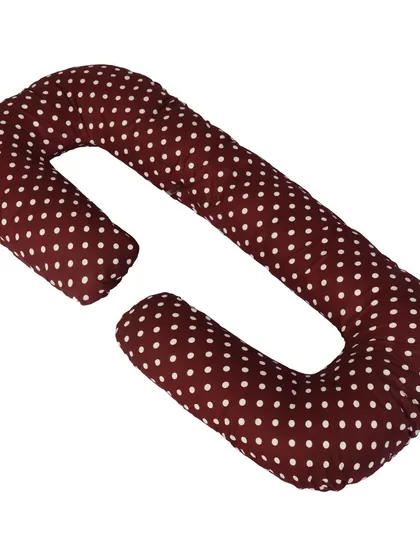 A C-shaped pregnancy pillow in maroon polka dot, with its detachable section shown.