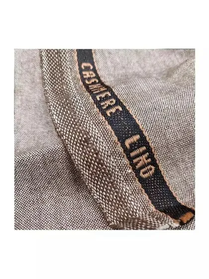 A detailed shot of a luxurious Cashmere Lino fabric. This blend is perfect for creating suits that are both warm and breathable, ideal for the Indian climate.