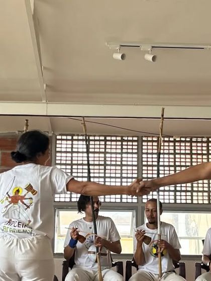 A moment of connection and sportsmanship in the roda at our Batizado. The game is a conversation, and it always ends with respect.
