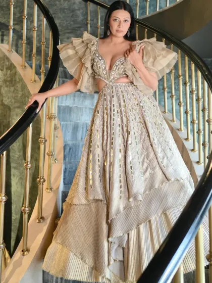 For a red carpet or a grand celebration, I focus on creating a look that is pure magic. This stunning couture gown with its dramatic ruffled sleeves, intricate cutouts, and shimmering fabric is all about making an unforgettable entrance. Styling for such events is about capturing a feeling of timeless elegance.