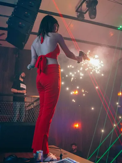 The "lady in red" commanding the stage with a sparkler gun. We love to create iconic, picture-worthy moments.