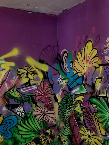 Another angle of the floral graffiti room, showing how the artwork wraps around the corner.