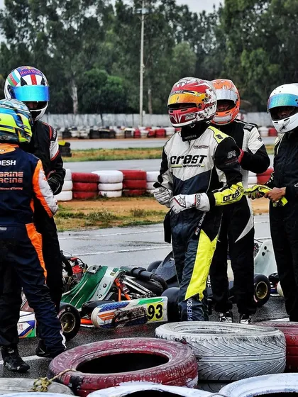 Drivers discussing strategy in the pit area.