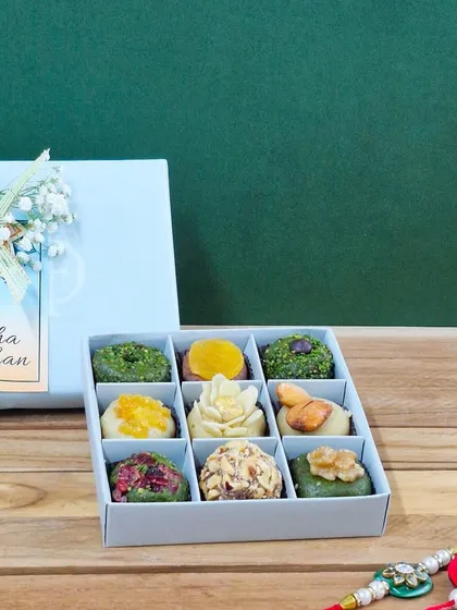 A close-up of my 'Rakhi ki Mitaas' box, showcasing the intricate, natural details of each piece. You can see the quality of the Peshawari pistachios, walnuts, and almonds used to create these healthy treats.