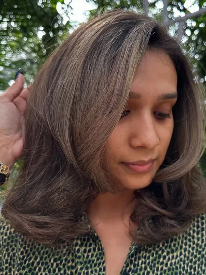 Getting her holiday-ready with a cool ash brown. This color is perfect for neutralizing unwanted warm tones and creating a sleek, modern look.