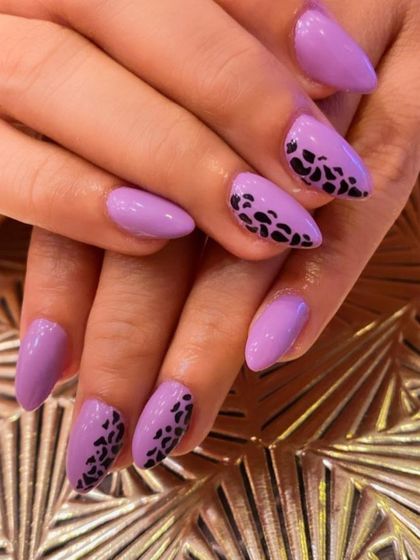 A trendy and chic design on almond-shaped nails. The full-coverage lavender polish is accented with a partial leopard print pattern at the tips.