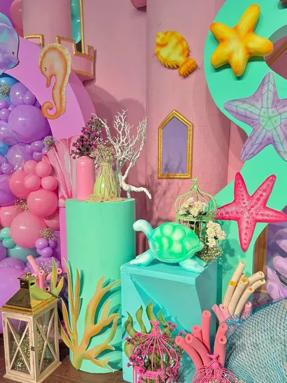 From a pastel soft play area and a cotton candy cart to a buffet with an LED screen backdrop showing aquatic life, every element was designed to immerse guests in Miraya's mermaid world.