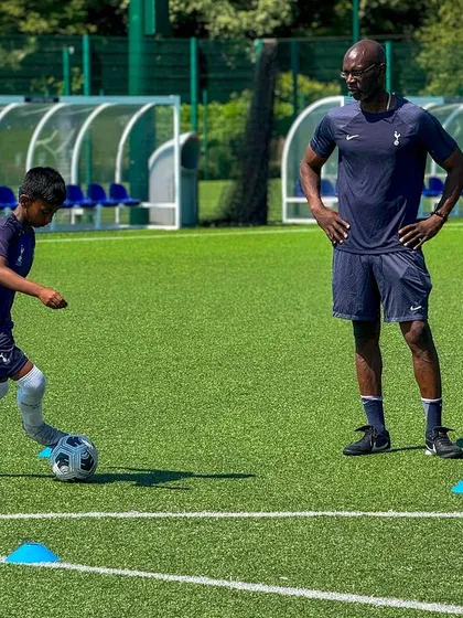 Our players learn from the best. Here, our young athletes receive direct instruction from Ose Aibangbee, a Tottenham Hotspur International Development Coach, during a training session, gaining insights into top-tier football philosophy.