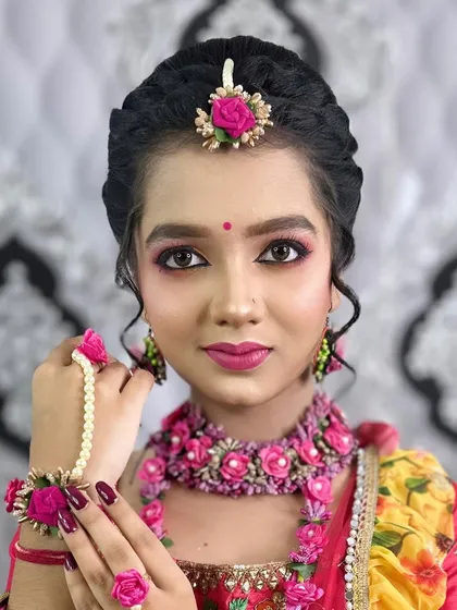 A beautiful portrait of the Haldi look, showing how the pink and yellow tones in the makeup complement the outfit.