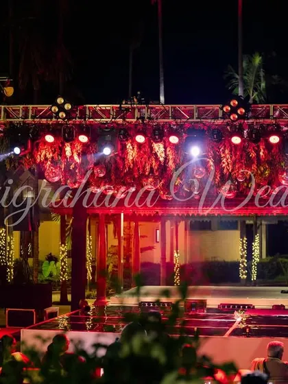 A wide shot of a Sangeet stage setup with a professional lighting truss, ready for a night of performances and partying.