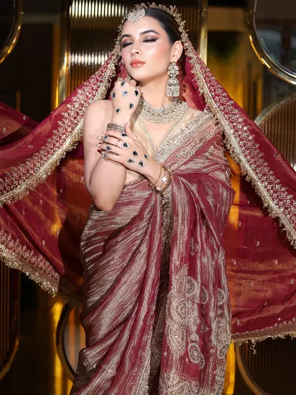 A dramatic pose with the dupatta flowing. The makeup remains the focus, with a strong contour and bold eyes.