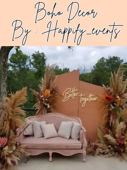 Showcasing a popular boho-themed decor style, perfect for outdoor engagements or anniversary celebrations. This setup features pampas grass, dried palm leaves, and a rustic color palette, complete with a comfortable vintage sofa and a "Better Together" sign.